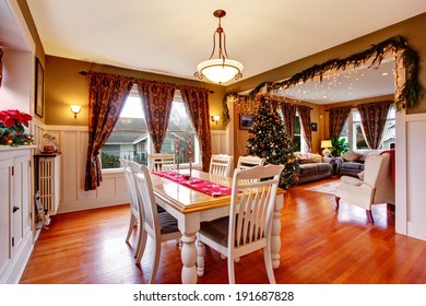 Light blue bedroom with two windows and hardwood floor. Furnished with black furniture set
