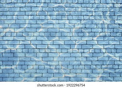 Light blue brick wall with water effect stain.