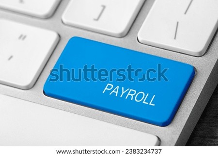 Light blue button with word Payroll on keyboard, closeup