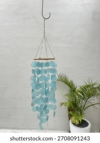 Light Blue Capiz Shell Wind Chime Hanging Outdoors, Coastal Home and Garden Decoration