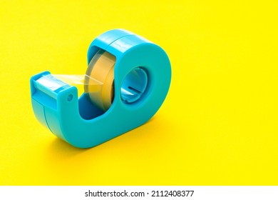 Light Blue Cellophane Tape. Yellow Background.