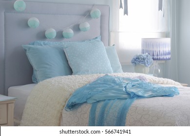 Light Blue Chiffon Dress On Beige Puffy Blanket In Light Blue Interior Bedroom