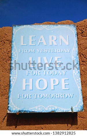 Light Blue Colored Inspirational Quote Board on the Clay Wall