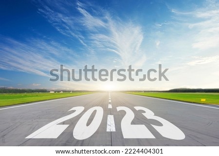 Light blue daytime sky and the inscription on the road 2023. The concept of a bright future, new plans and ideas