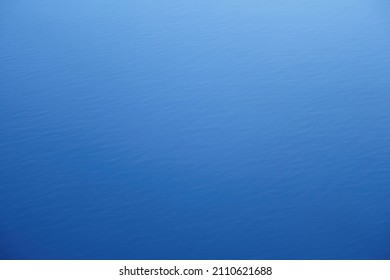 Light blue fade to dark blue background simulating the effect of sunlight on an ocean - intentional  defocus