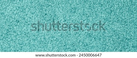 Light blue fluffy background of soft, velour fabric. Texture of turquoise wool textile backdrop, closeup.