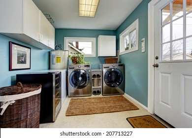 Light Blue Laundry Room With Modern Steel Appliances And White Cabinets