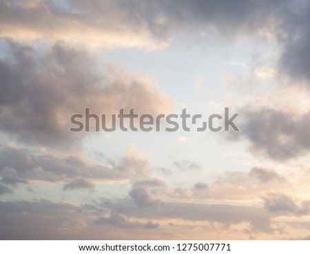 Light blue orange sky with sun peaking through clouds aesthetic tumblr background