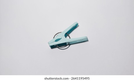 Light Blue Plastic Clothespin on White Background, Minimal Household Concept
