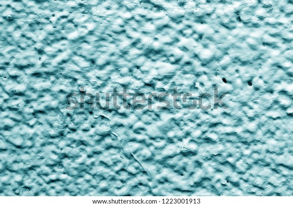Light Blue\
relief wall of the house. Dirty shabby wall with putty. Relief\
paint of light blue color. The wall paint is like clouds and sky.\
View of the mountains and craters of the\
moon.