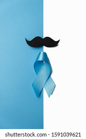 Light blue ribbon with mustache on white and blue background. Prostate Cancer Awareness, Movember Men's health awareness. Healthcare, International men, Father and World cancer day concept.
