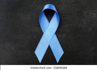 Light Blue Ribbon On Dark Background. Prostate Cancer Concept