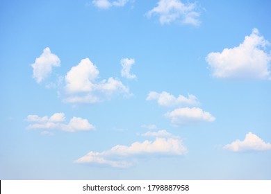 Light blue sky with rare white clouds, may be used as background