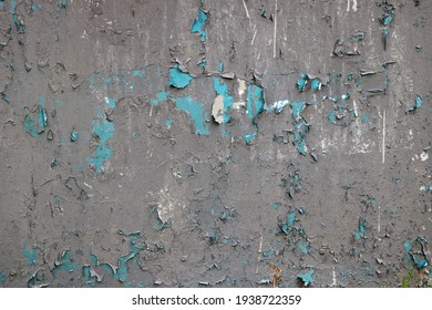 light blue wall with gray peeling paint and chipped - rough texture for a damaged background