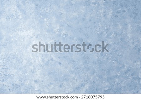 Light blue wall texture with soft mottled pattern and plaster effect