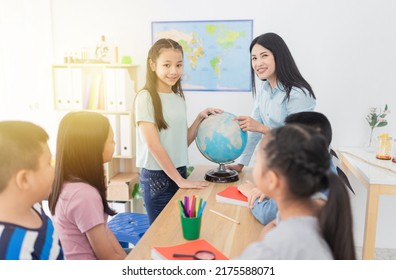 Light And Blur People, Asian Children Students Group Learning About World Map And History With Female Teacher, They Feeling Fun And Happy In Classroom, Happiness Elementary School