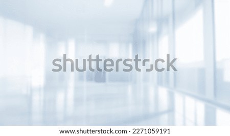Light blurred background. The lobby of an office or medical institution with panoramic windows and a perspective.