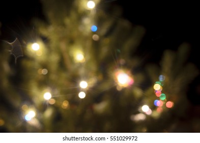 Light Blurred Multicolored Lights On A Real Christmas Tree Outside In The Snow. Bokeh.