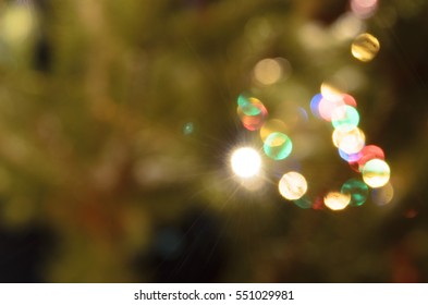 Light Blurred Multicolored Lights On A Real Christmas Tree Outside In The Snow. Bokeh.