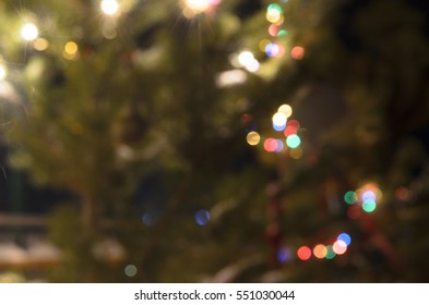 Light Blurred Multicolored Lights On A Real Christmas Tree Outside In The Snow. Bokeh.