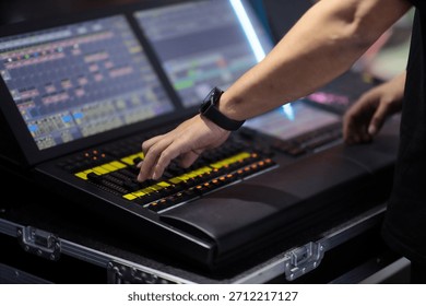 Light board operator programs lighting control console. Selective focus.
