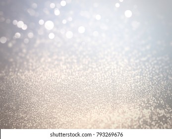 Light Bokeh White on Blurred Background of Silver and Golden Glitter in Festival and Fashion Concept ,Free Copy Space.