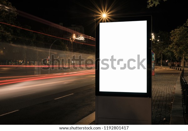 Light box display with white blank space for\
advertisement. Mock-up design concept with beautiful car light\
trails at night. Long\
exposure.