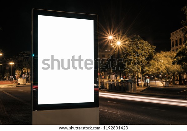 Light box display with white blank space for\
advertisement. Horizontal mock-up design concept with car light\
trails at night.