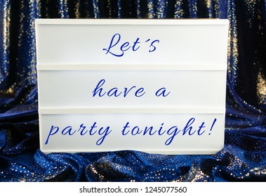 Light Box With The Words Let´s Have A Party Tonight, Blue And Sparkling Curtain In The Background