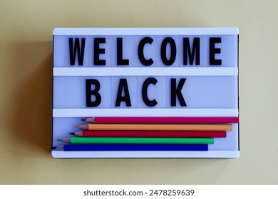 light box with words WELCOME BACK and colored pencils - Powered by Shutterstock