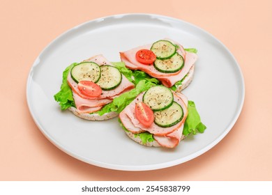 Light Breakfast. Quick and Healthy Sandwiches. Rice Cakes with Ham, Tomato, Fresh Cucumber and Green Salad on White Dish - Powered by Shutterstock