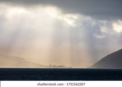 Light Breaks Through The Clouds Over Lake Aviemore In New Zealand - Powered by Shutterstock - Get 15% off with code: PIKWIZARD15