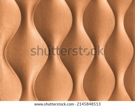 Light brown 3D interior decorative wall panel with unusual wavy geometric shape. Wooden beige background with wave pattern. Abstract texture ornate. Bronze backdrop