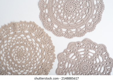 Light brown crochet doilies on a white background