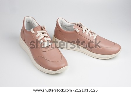 Light brown faux leather shoes with laces. Close-up shot.