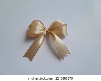 Light brown ribbon bow made of satin ribbon, ribbon hampers, handmade. Isolated on a white background. - Shutterstock ID 2248888575