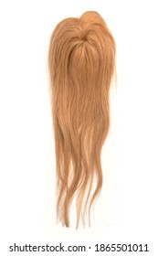 A Light Brown Wavy Wig Or Hair Topper On A White Background.