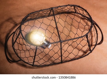 Light bulb in a cage.Creative concept.Idea concept.