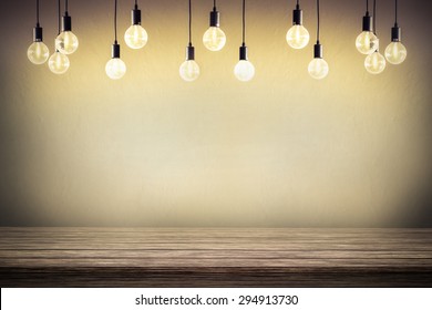 Light bulb with cement wall background,wood table