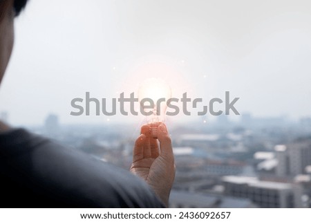 A light bulb in creativity develops new ideas and innovations leading to a new era of the future, by one man and a small beacon of light that shines in the middle of darkness and a pioneer and leader.