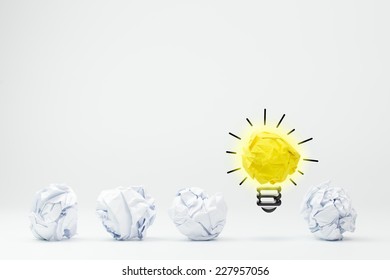 Light Bulb With Crumpled Paper Balls On White Background