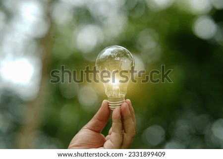 Light bulb Energy saving green nature background...