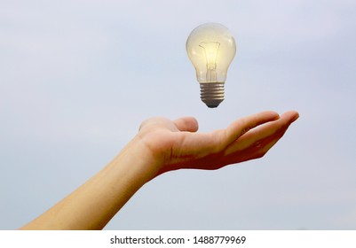 Light bulb is floating above hand