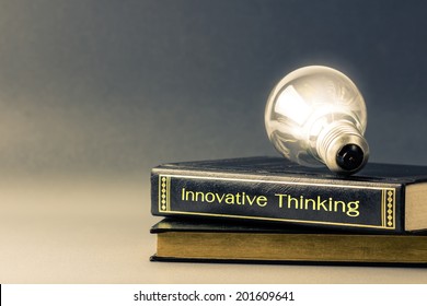 Light Bulb Glowing On The Innovative Thinking Book