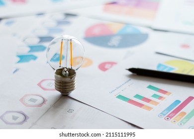 Light bulb with graph information document. Businessperson analysis data for corporate or entrepreneur planning for small business growth or success. Business and financial idea concept