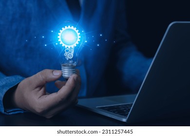 a light bulb in the hand of a businessman thinking and creativity, personality, identity, uniqueness, creative process and problem solving - Shutterstock ID 2311257445