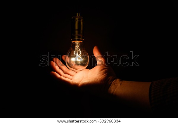 Light bulb and hand,\
concept of wisdom.