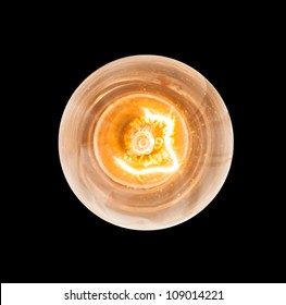 Light bulb illuminated and taken from above and isolated against black - Shutterstock ID 109014221