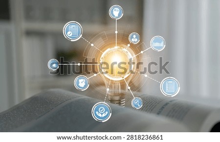 A light bulb illuminates various digital icons that symbolize knowledge and innovation in a contemporary workspace setting, highlighting themes of growth and creativity. Crux