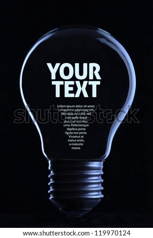 Light bulb on black background with copy text